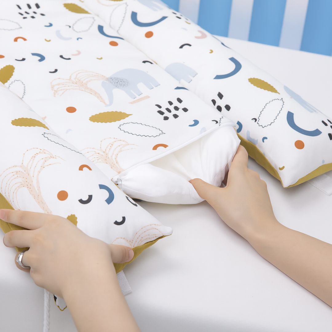 Babiesoul baby nest sleep pod with soft cushioned sides and animal print being adjusted by hands