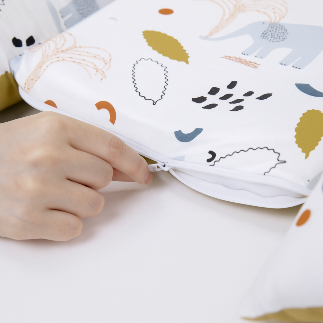 Close-up of Babiesoul baby nest sleep pod zipper with animal and leaf pattern fabric